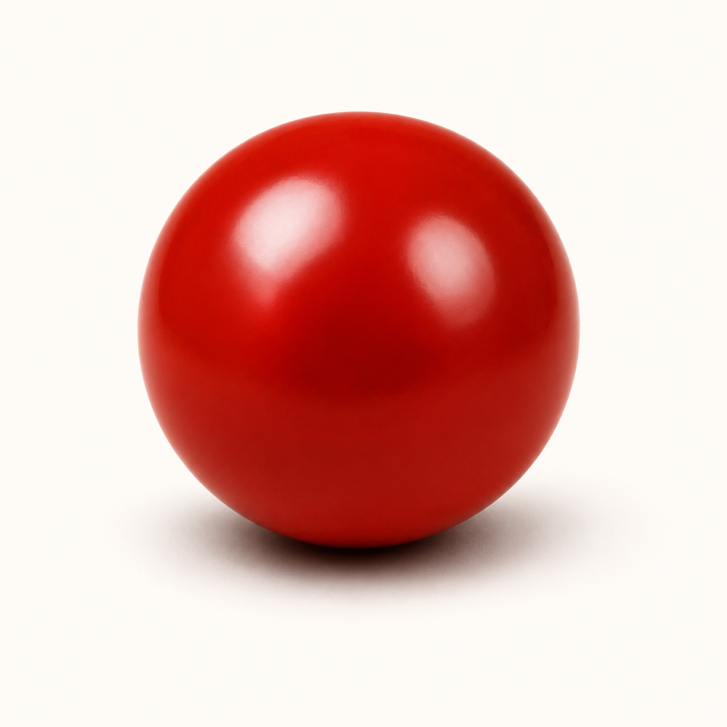 Shiny red sphere on cream backdrop